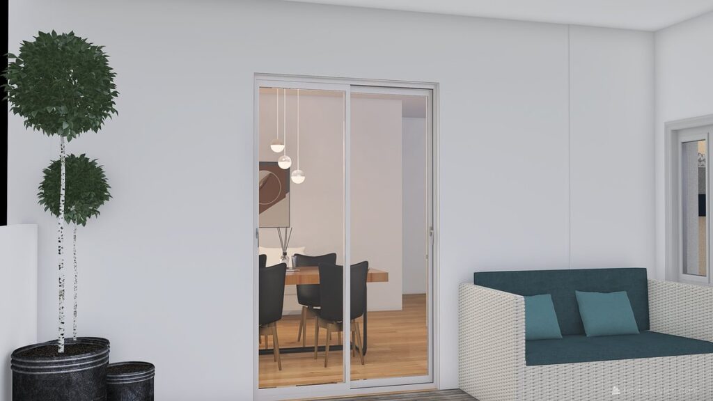 Un salon moderne avec canapé, porte vitrée ouvrant sur une salle à manger